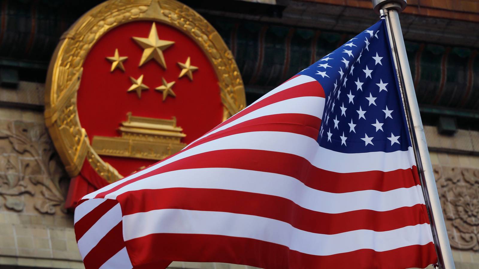 American flag is flown next to the Chinese national emblem