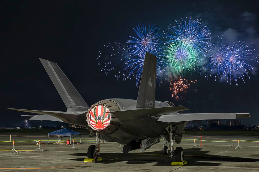 A Japan Air Self-Defense Force F-35A Lightning II Joint Strike Fighter sits at Yokota Air Base during a fireworks display. 
