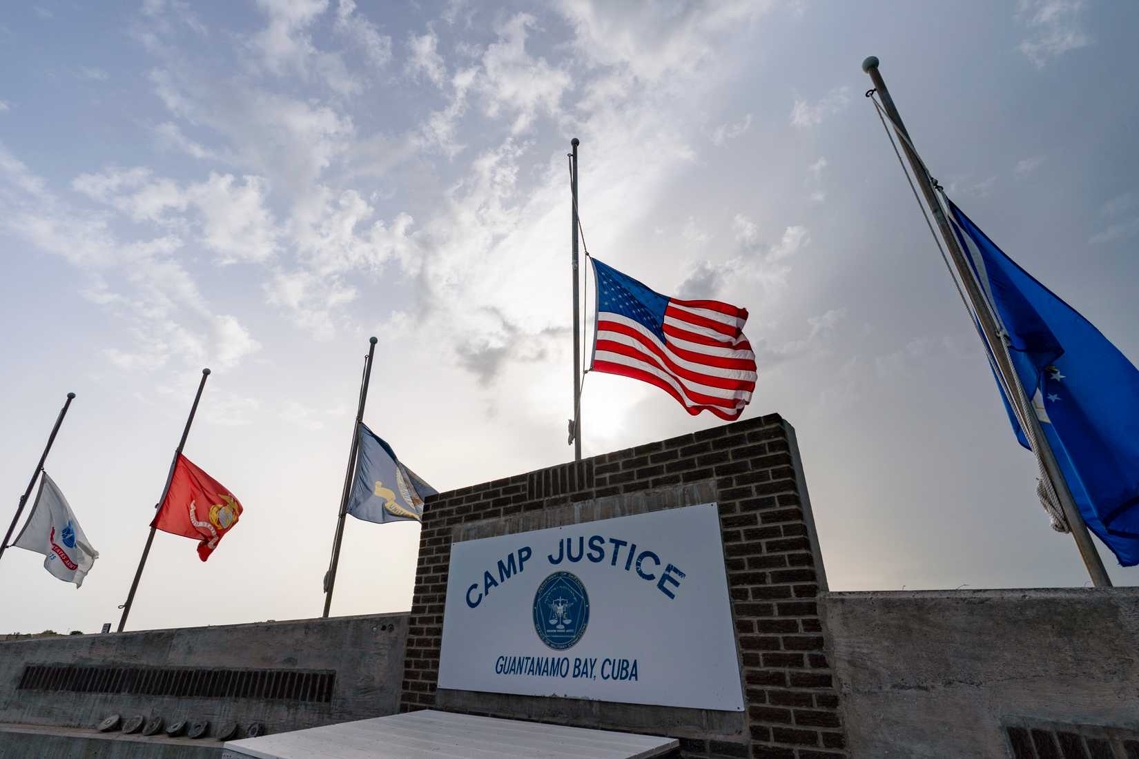 flags fly at half-staff at Camp Justice, Aug. 29, 2021, in Guantanamo Bay Naval Base
