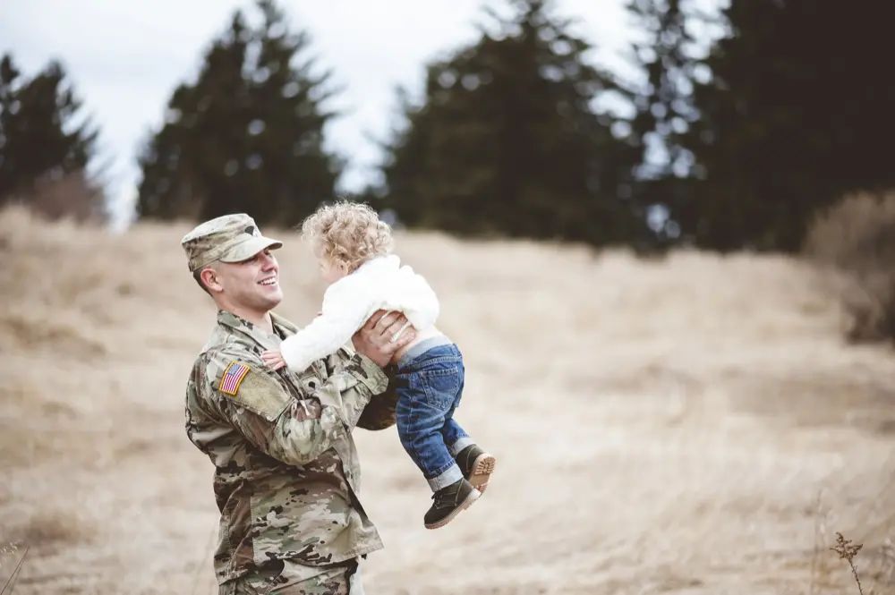 military member holding child