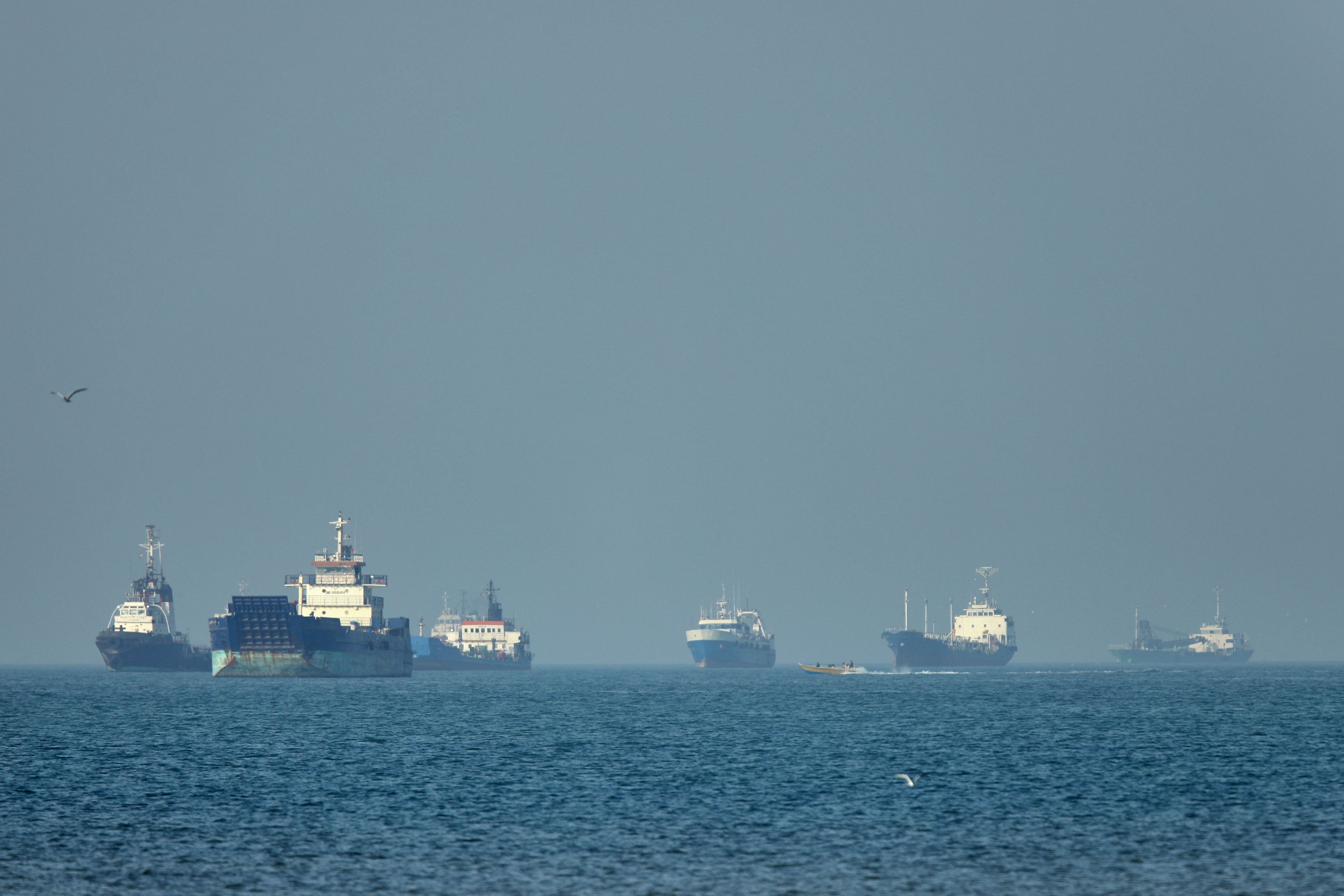 Cargo ships sit at anchor in the Strait of Hormuz.