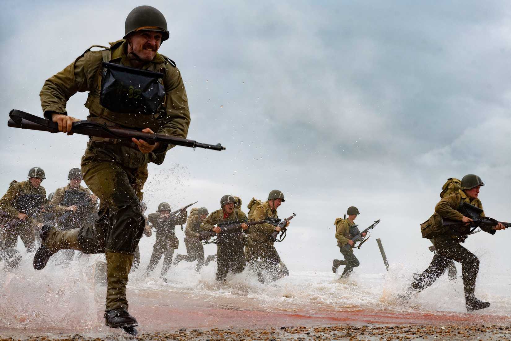 Soldiers run through surf during a D-Day beach landing scene in Pressure.