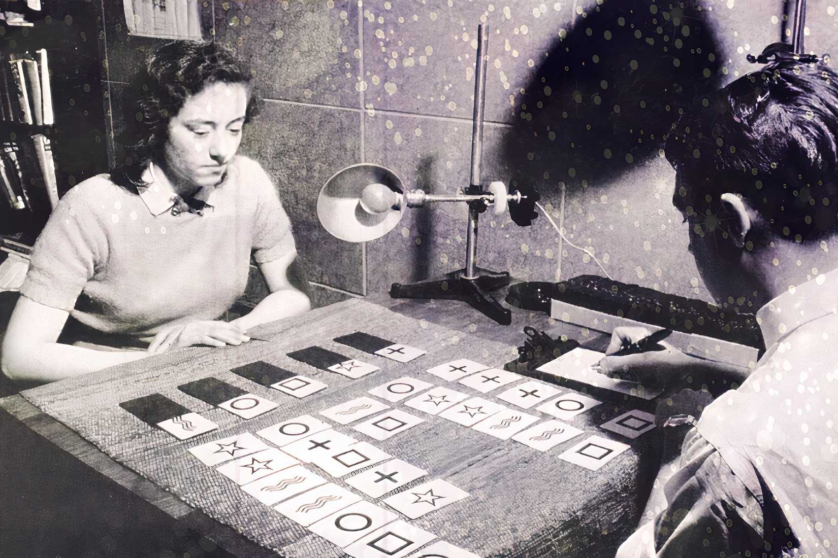 A black-and-white image of an extrasensory perception research session with cards on a table, used to illustrate remote viewing history.