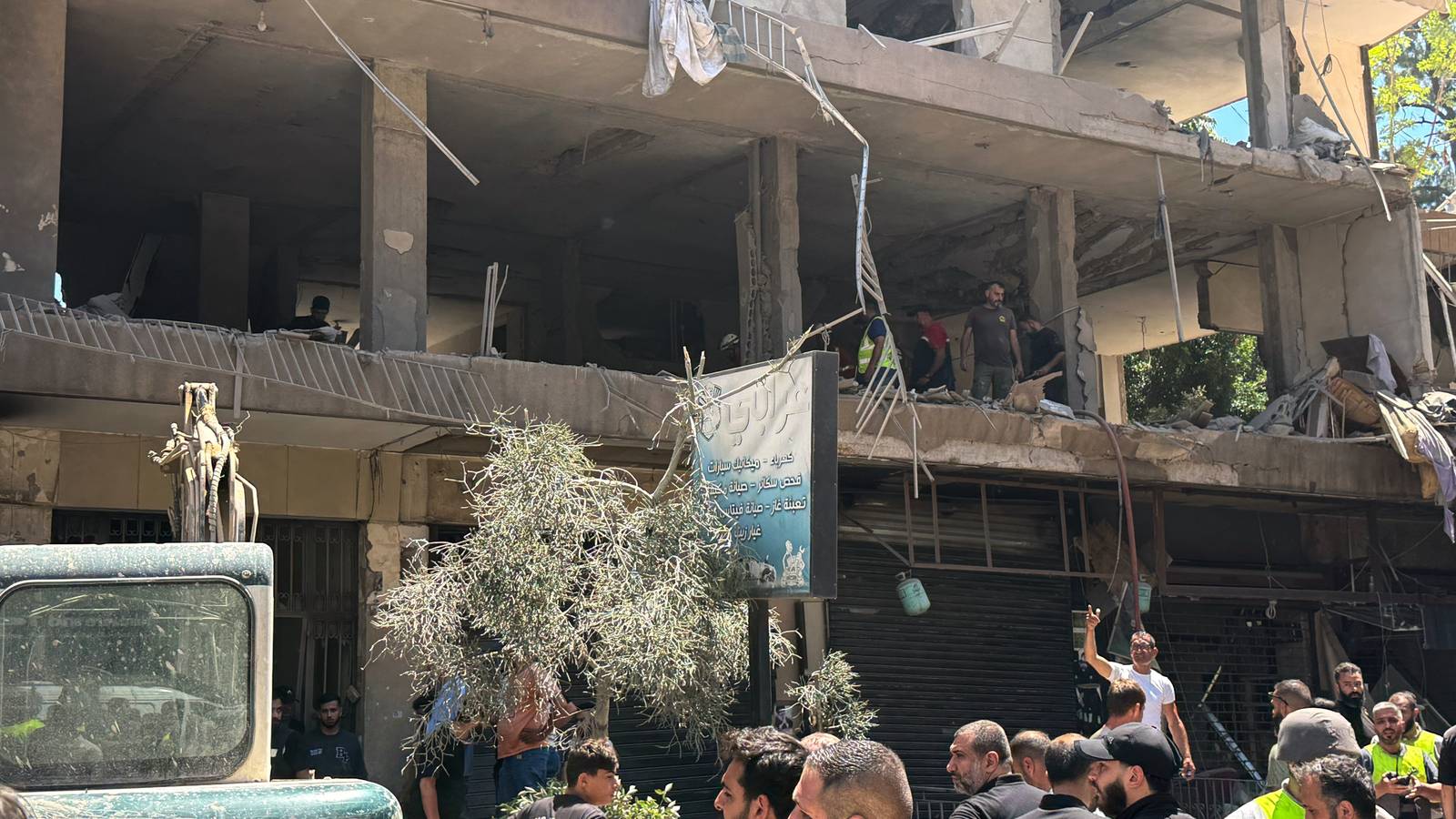 People gather at the site of an Israeli airstrike that struck an apartment in Lebanon.