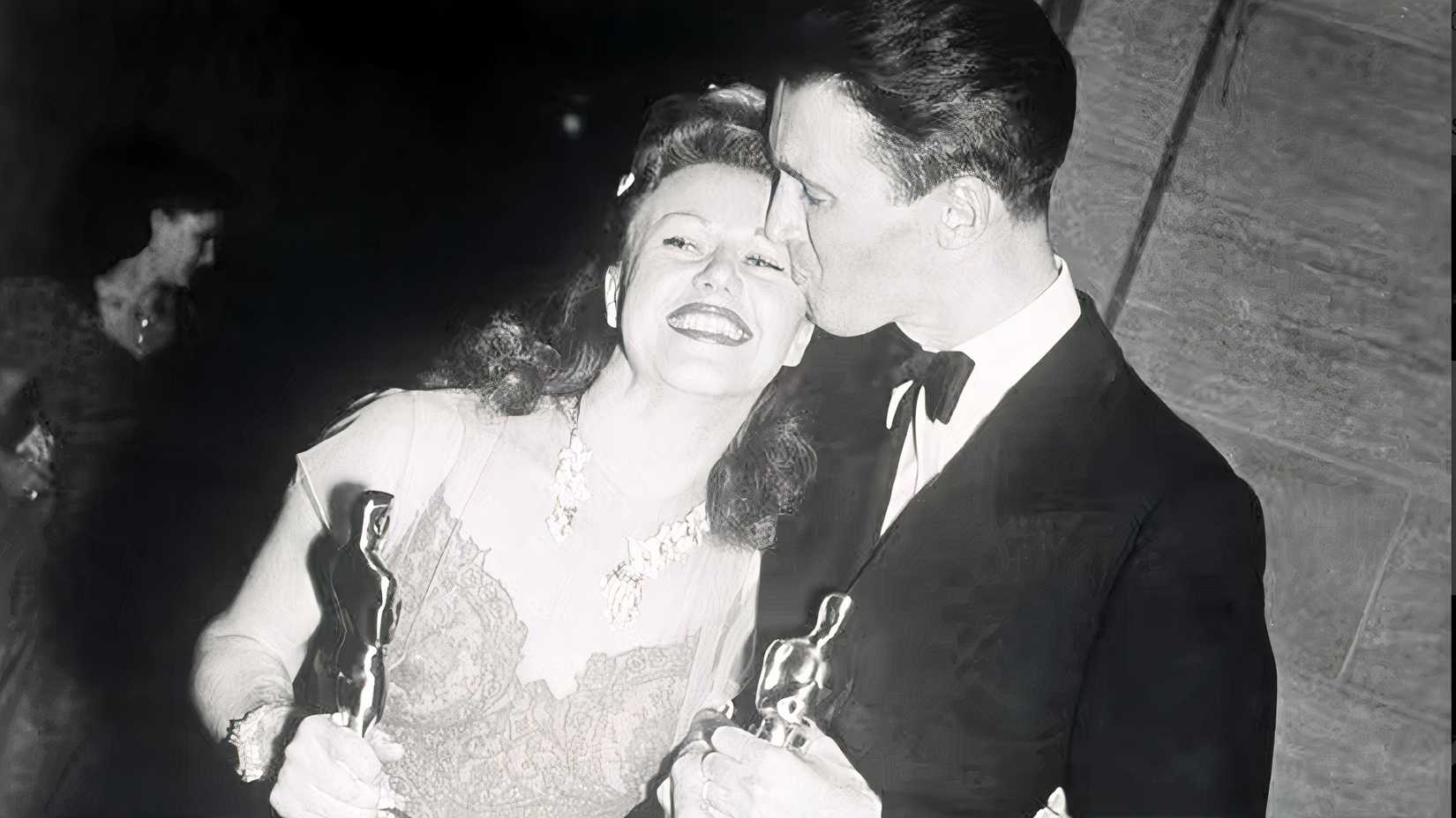 Ginger Rogers and Jimmy Stewart hold Academy Awards in a 1941 Oscars photo.