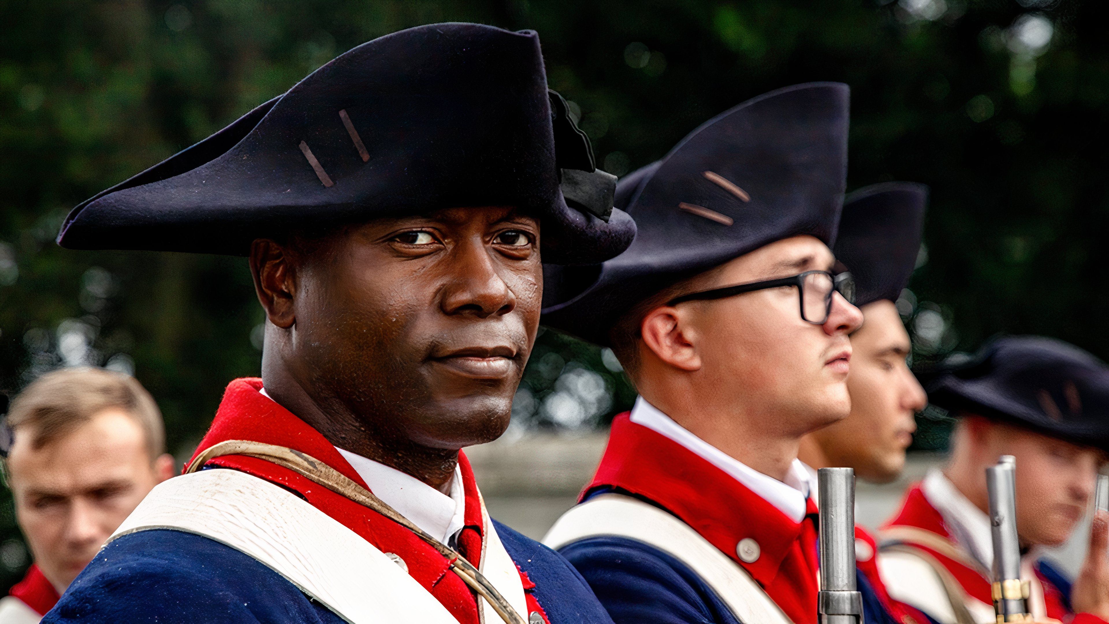 An Old Guard soldier in Revolutionary War-era uniform stands during Lexington’s 250th anniversary commemoration.
