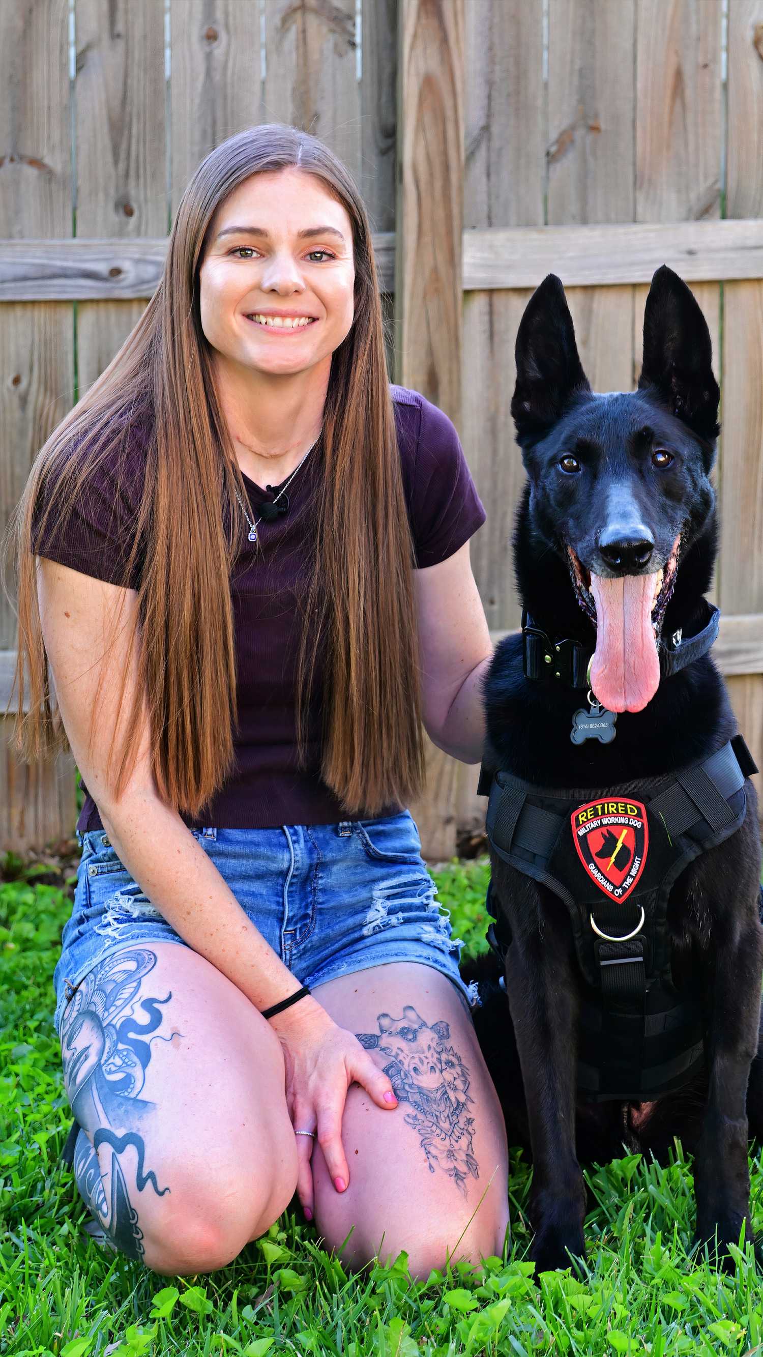 Rebecca Anderson pets Boss after the retired military working dog returned to her in Missouri.