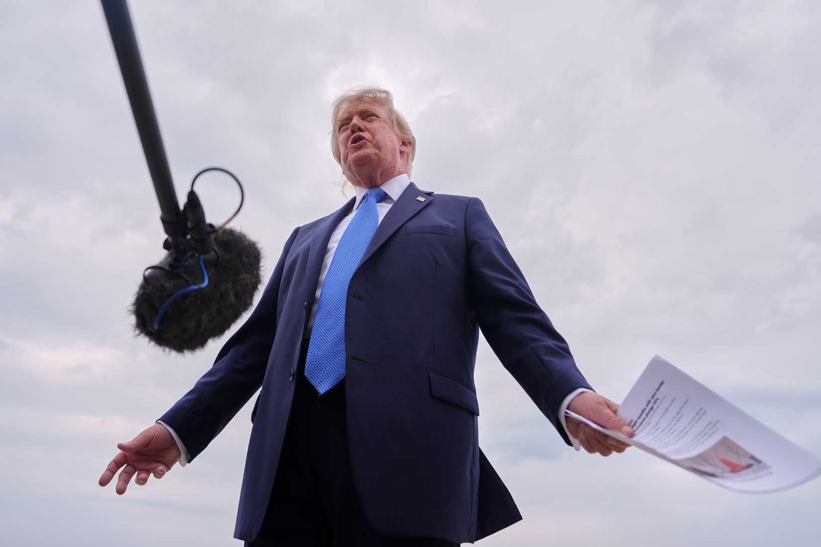 President Trump speaks with reporters before boarding Air Force One, Friday, Aug. 14, 2026, at Joint Base Andrews, Md. (AP Photo/Julia Demaree Nikhinson)