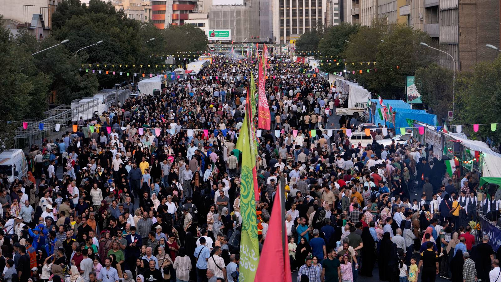 Crowds fill a street in Tehran, Iran.
