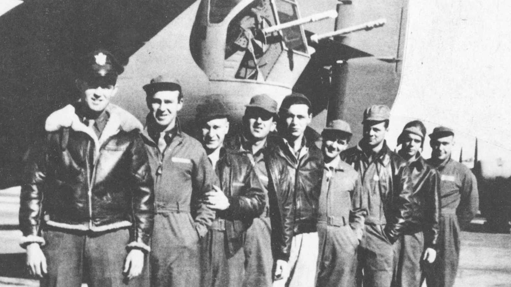 Nine crew members of the B-24 Lady Be Good stand beside their bomber before its final mission.