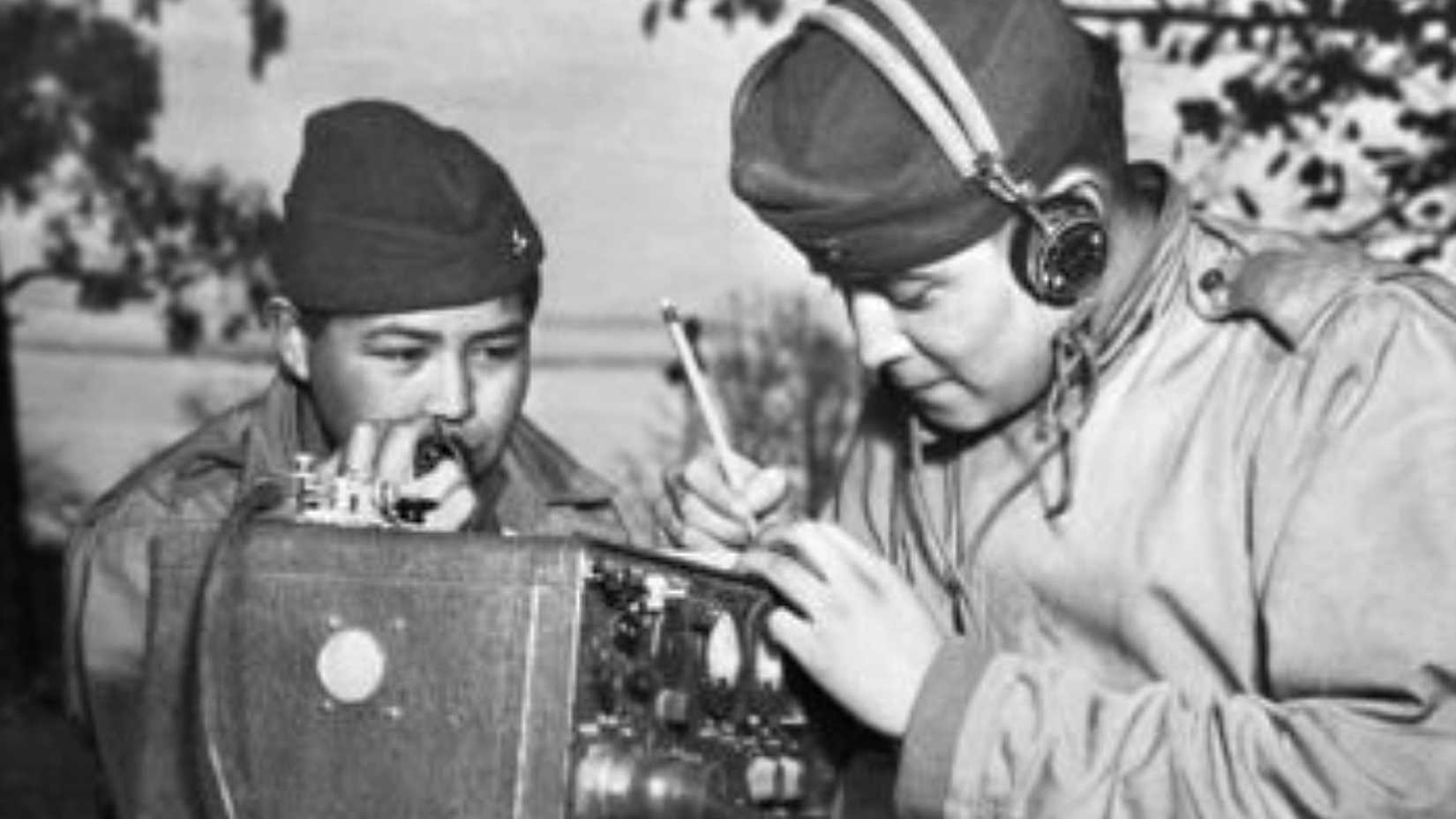 Two Navajo Code Talkers operate a field radio during World War II.