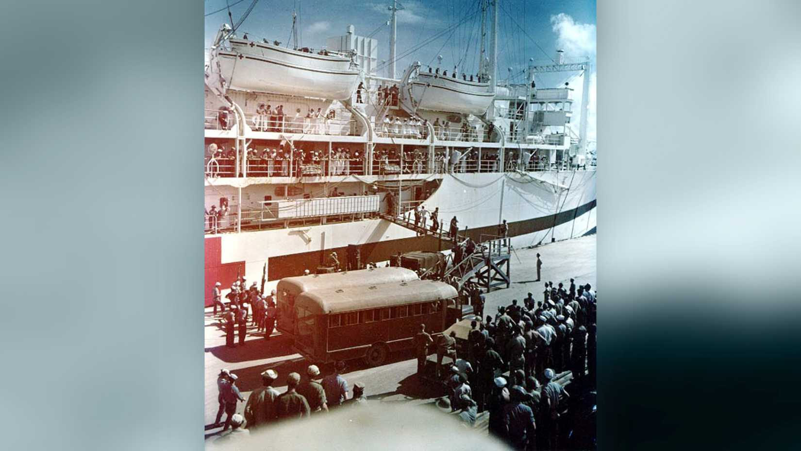USS Indianapolis survivors arrive at Guam as ambulances wait beside the hospital ship USS Tranquility.