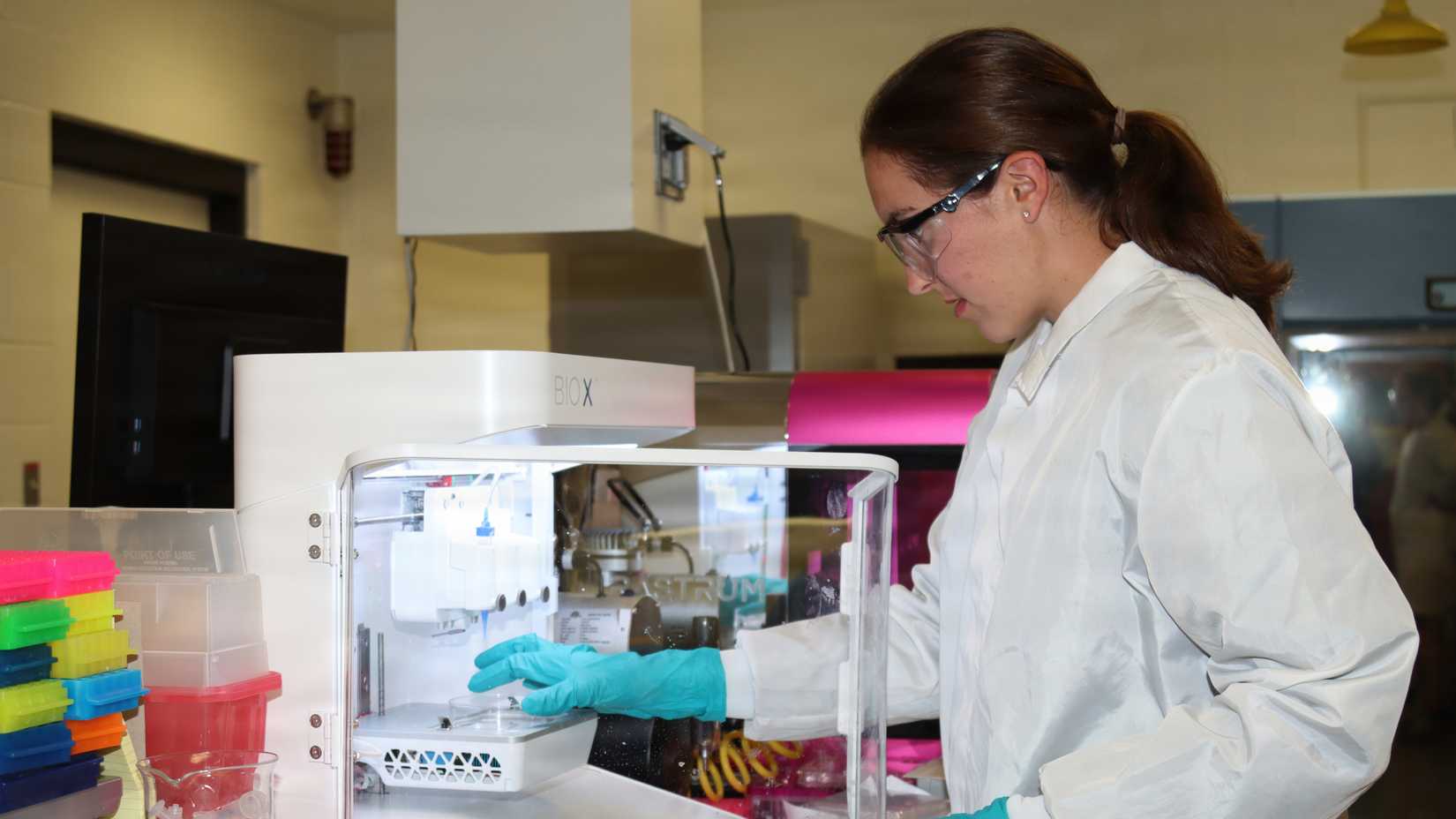 U.S. Military Academy Cadet Elly Melton wears safety glasses and a lab coat while calibrating a 3D bioprinter at an Army laboratory in Maryland.