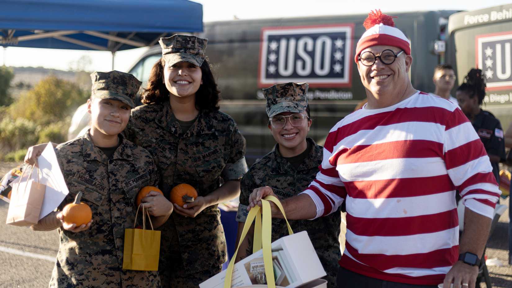 Three Marines pose with a man dressed as Where's Waldo during a Halloween event at Camp Pendleton.