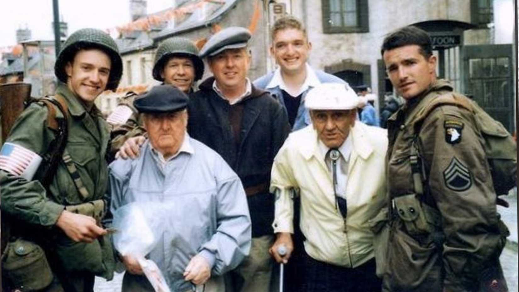 Easy Company veterans Bill Guarnere and Babe Heffron pose with cast members on the set of Band of Brothers.