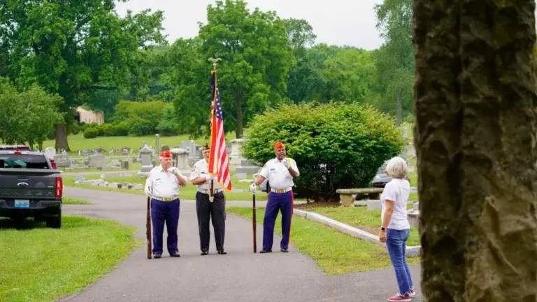 Hopkinsville VFW Commander John Brame, pictured with flag in one of the cemeteries where veterans' grave markers were desecrated and stolen. (VFW Post 1913).