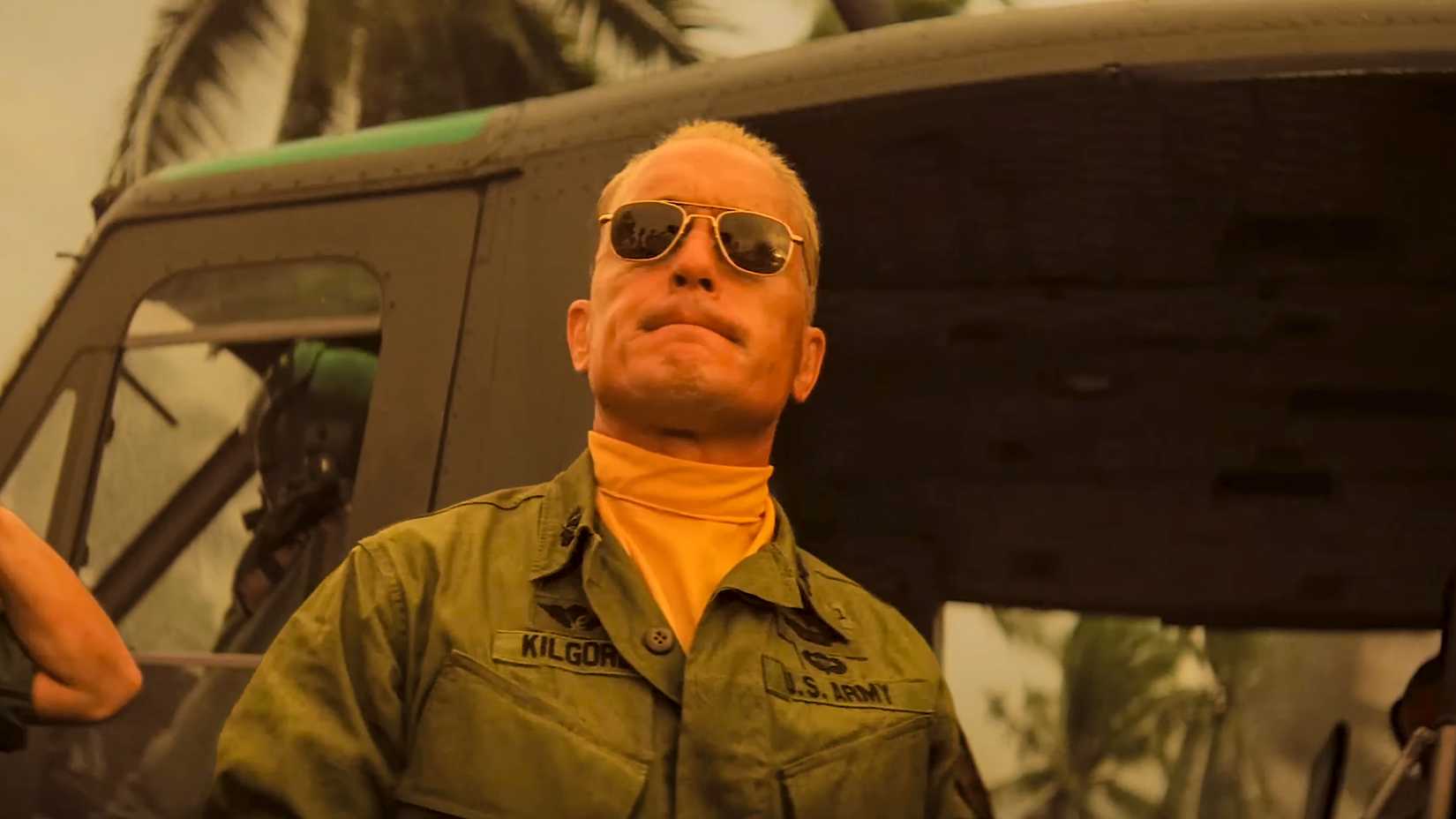 Robert Duvall wearing aviator sunglasses and a yellow neckerchief as Army Lt. Col. Bill Kilgore beside a helicopter in Apocalypse Now.